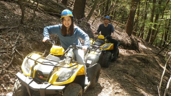 山梨県南都留郡にあるカントリーレイクシステムズで四輪バギーを体験するカップルの様子